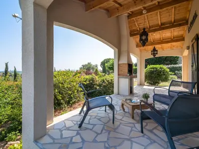 an outdoor patio with chairs and a table with a view at Relaxing Villa Near Lake & Beaches in Beaufort