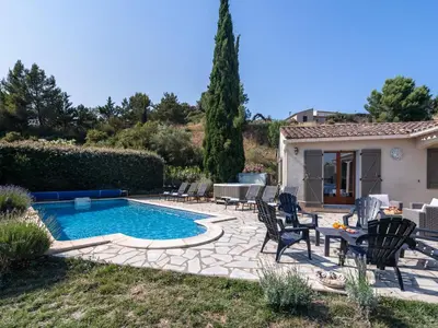 a pool with chairs and a table in front of a house at Relaxing Villa Near Lake & Beaches in Beaufort