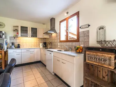 a kitchen with white cabinets and a window and a sink at Relaxing Villa Near Lake & Beaches in Beaufort