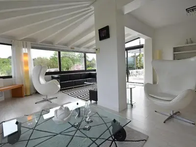 a living room with two white chairs and a glass table at Villa in Malves near Carcassonne Pool in Malves-en-Minervois