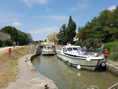 two boats are docked in a small canal at Villa in Malves near Carcassonne Pool in Malves-en-Minervois