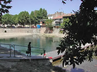 a woman and a child standing on a bridge over water at Villa in Malves near Carcassonne Pool in Malves-en-Minervois