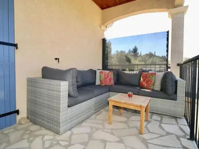 a living room with a couch and a table at Villa near Carcassonne with Heated Pool in Félines-Minervois