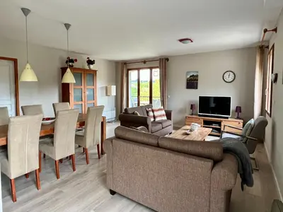 a living room with a couch and a dining room at Villa near Carcassonne with Heated Pool in Félines-Minervois