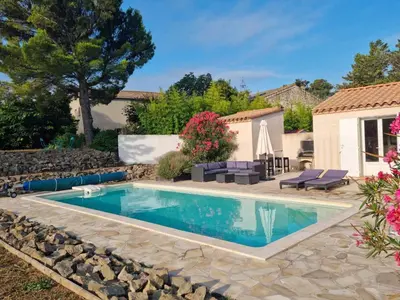a swimming pool in a yard with a house at Villa in Castelnau d'Aude with Heated Pool in Castelnau-dʼAude