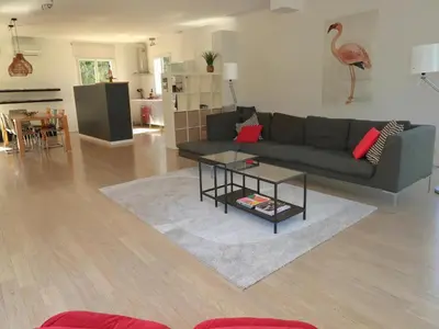 a living room with a couch and a table at Villa in Castelnau d'Aude with Heated Pool in Castelnau-dʼAude
