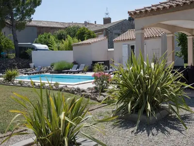 a backyard with a swimming pool and plants at Villa in Castelnau d'Aude with Heated Pool in Castelnau-dʼAude
