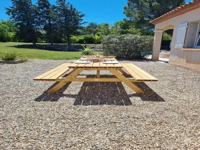 a picnic table sitting on top of a pile of gravel at Villa in Castelnau d'Aude with Heated Pool in Castelnau-dʼAude