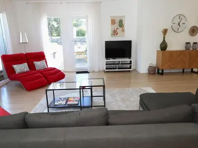 a living room with a couch and a tv at Villa in Castelnau d'Aude with Heated Pool in Castelnau-dʼAude