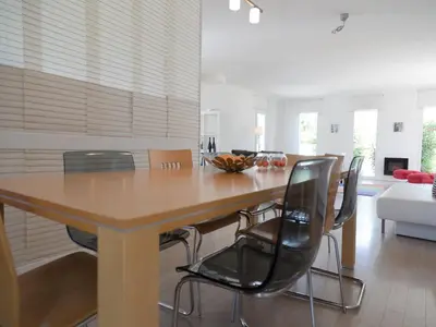 a dining room with a wooden table and chairs at Villa in Castelnau d'Aude with Heated Pool in Castelnau-dʼAude