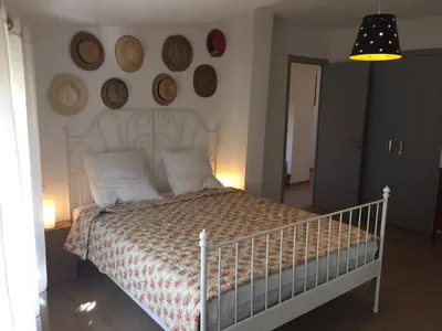 a bedroom with a white bed and a wall with plates at Villa in Olonzac with Pool near Lac du Jouarres in Olonzac