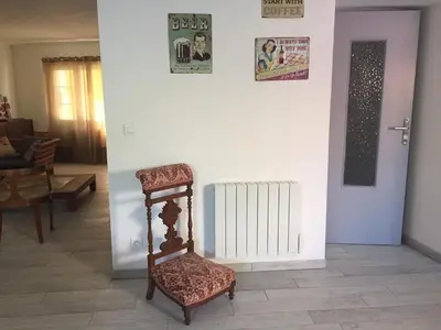 a living room with a chair and a radiator at Villa in Olonzac with Pool near Lac du Jouarres in Olonzac