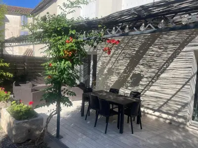 a black table and chairs under a pergola at Villa in Olonzac with Pool near Lac du Jouarres in Olonzac