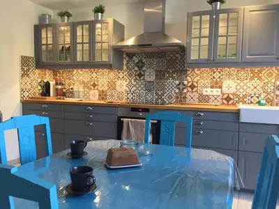 a kitchen with a blue table and blue chairs at Villa in Olonzac with Pool near Lac du Jouarres in Olonzac