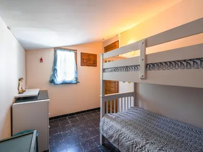 a bedroom with a bunk bed and a staircase at Villa in Pouzols with Private Pool in Pouzols-Minervois