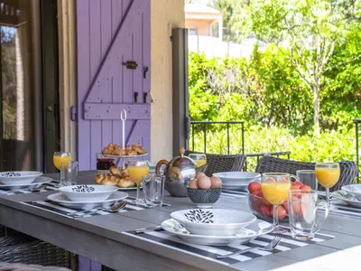 a table with plates and bowls of food on it at Villa in Pouzols with Private Pool in Pouzols-Minervois