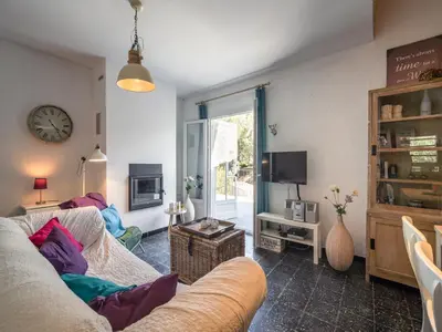 a living room with a couch and a tv at Villa in Pouzols with Private Pool in Pouzols-Minervois