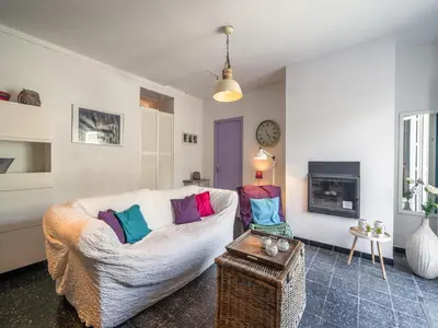 a living room with a couch with colorful pillows at Villa in Pouzols with Private Pool in Pouzols-Minervois