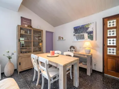 a dining room with a table and a desk at Villa in Pouzols with Private Pool in Pouzols-Minervois