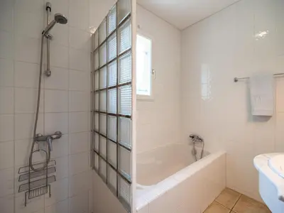 a white bathroom with a tub and a sink at Spa Oasis Near Canal du Midi in Félines-Minervois