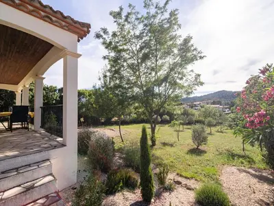 a view from the porch of a house with a garden at Spa Oasis Near Canal du Midi in Félines-Minervois