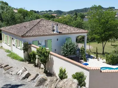 a villa with a swimming pool and a house at Spa Oasis Near Canal du Midi in Félines-Minervois