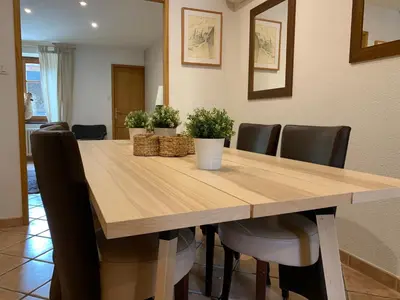 a dining room with a wooden table and chairs at Côte de la Cité in Carcassonne