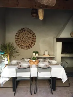 a dining room with a white table and chairs at Côte de la Cité in Carcassonne