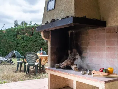 an outdoor brick oven with a table and chairs at Villa in Beaufort with Pool & Views in Beaufort