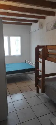 a room with a bed and a window at Gite Rouge à la mer climatisation dans toutes les pièces in Port-la-Nouvelle