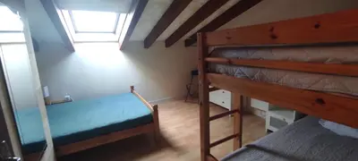 a bedroom with two bunk beds and a window at Gite Rouge à la mer climatisation dans toutes les pièces in Port-la-Nouvelle