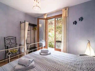 a bedroom with a large bed and a window at Charming French Villa with Pool in Cébazan