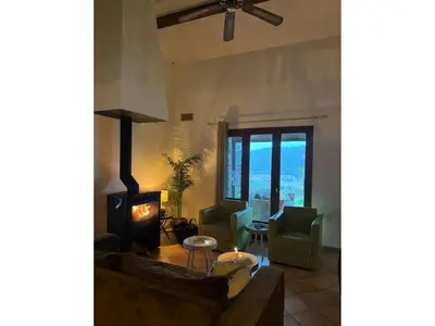a living room with a couch and a wood stove at Charming French Villa with Pool in Cébazan