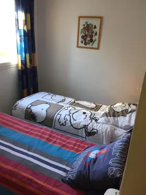 a bedroom with a bed with cows on it at T 3 appart les jardins du phœbus in Gruissan