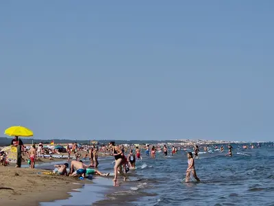 a large group of people on the beach at Gruissan Village APPT Duplex 51m2 in Gruissan