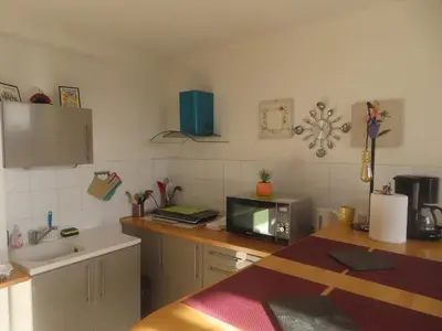 a kitchen with a counter top with a microwave at Gruissan Village APPT Duplex 51m2 in Gruissan