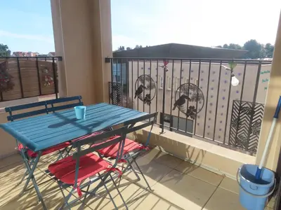 a blue table and chairs on a balcony at Gruissan Village APPT Duplex 51m2 in Gruissan