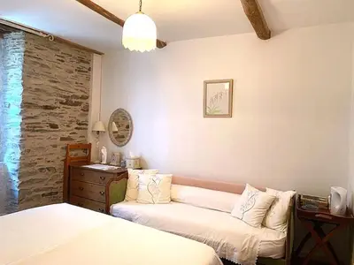 a room with a bed and a couch in it at Chez Providence Chambres et Table d'Hôtes in Cuxac-Cabardès