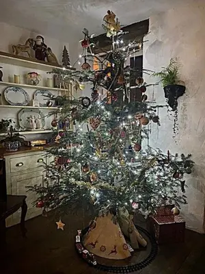 a christmas tree with ornaments on it in a kitchen at Chez Providence Chambres et Table d'Hôtes in Cuxac-Cabardès