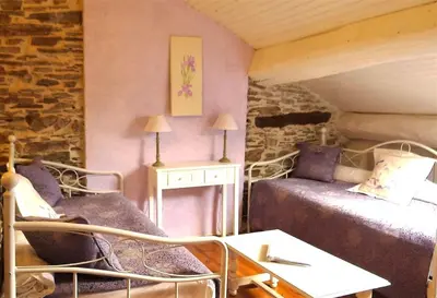 a room with a bed and a couch and a table at Chez Providence Chambres et Table d'Hôtes in Cuxac-Cabardès