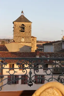 a view from a balcony of a building with a clock tower at Hôtel Rivière in Castres