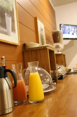 a counter with two glasses of orange juice on it at Hôtel Rivière in Castres