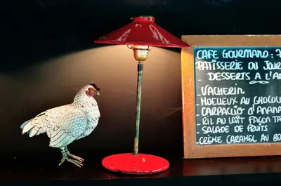 a red lamp with a turkey next to a sign at Relais Fasthotel Port Lauragais in Avignonet-de-Lauragais