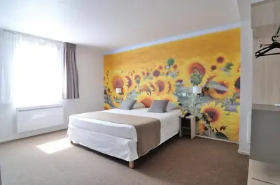 a bedroom with a bed and a painting of flowers at Relais Fasthotel Port Lauragais in Avignonet-de-Lauragais