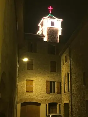 a building with a red cross on top of it at night at Chambre Familiale du Couvent in Narbonne