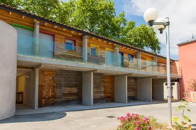an exterior view of a building with a balcony at Hôtel du Canal in Castelnaudary