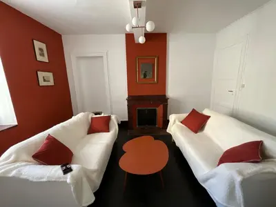 a living room with two white couches and a table at Le Clos Saint Michel in Carcassonne