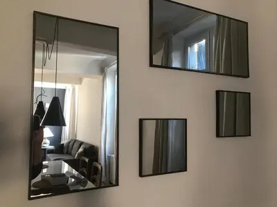 four mirrors on a wall with a living room at Le Clos Saint Michel in Carcassonne