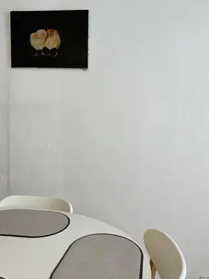 a table with chairs and a picture on the wall at Le Clos Saint Michel in Carcassonne