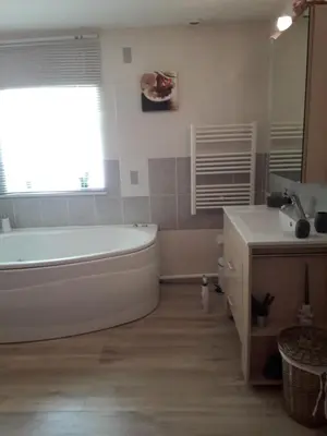 a bathroom with a white tub and a sink at gite tout confort in Montolieu